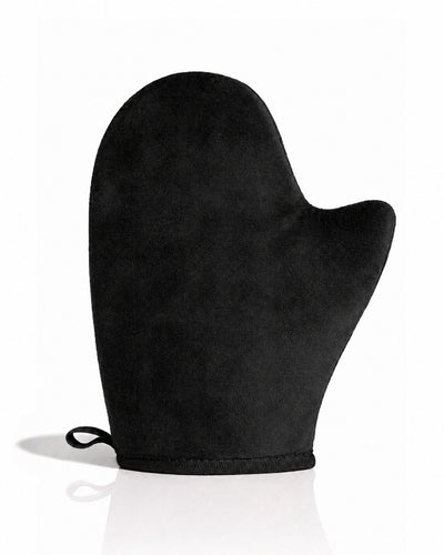 A single black self tanning mitt with a small hanging loop at the wrist, photographed on a clean white background with a soft reflection underneath.