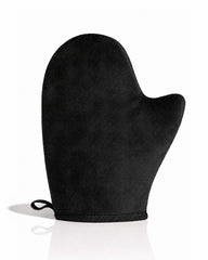 A single black self tanning mitt with a small hanging loop at the wrist, photographed on a clean white background with a soft reflection underneath.