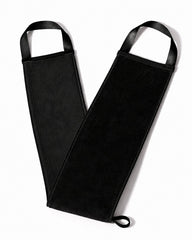 A black self tanning back mitt with arm guards and integrated black straps, laid flat on a white background.