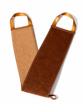 Brown leather bottle holder with tan handles on a white background