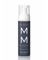 Sunless tanning mousse bottle with 'MM' branding on a white for men self tanning