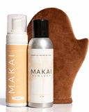 Two bottles of Makai sunless tanning products and a brown mitt on a white background