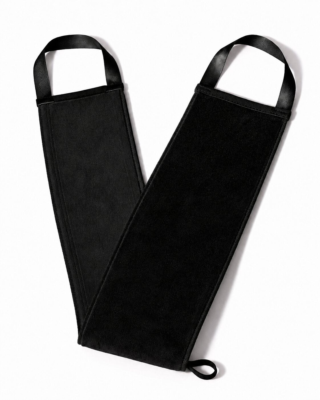 A black self tanning back mitt with arm guards and integrated black straps, laid flat on a white background.